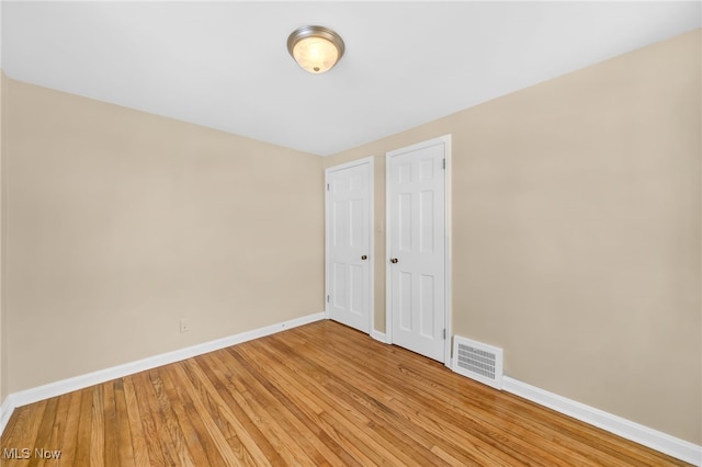 spare room with light wood-type flooring