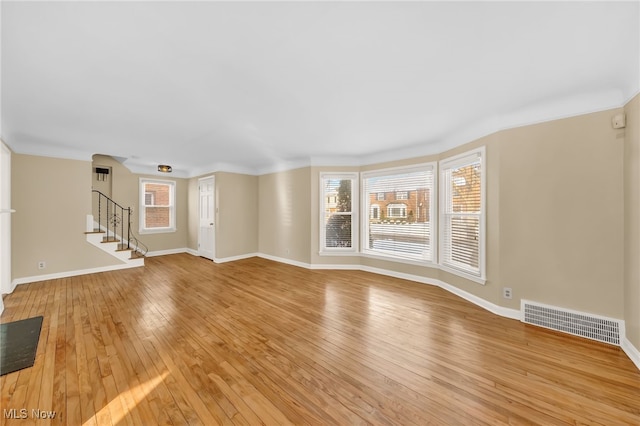 unfurnished living room with light wood-type flooring