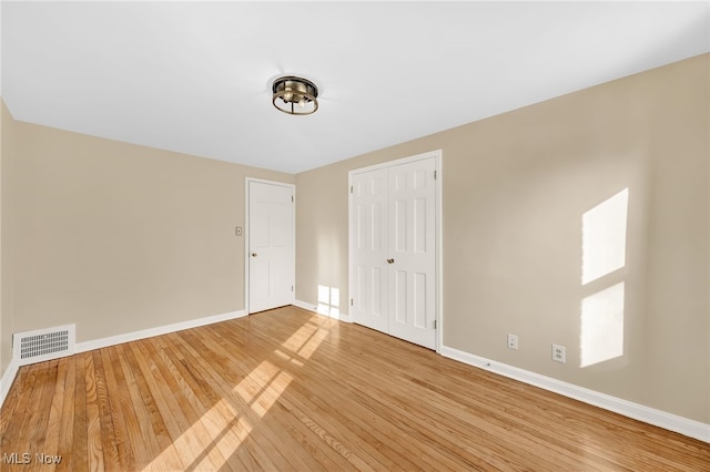 spare room featuring hardwood / wood-style floors