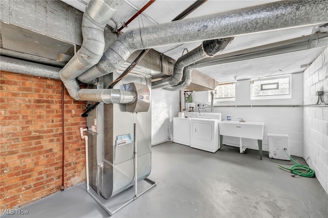 basement with separate washer and dryer and heating unit