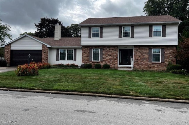 view of front of property with a garage and a front yard