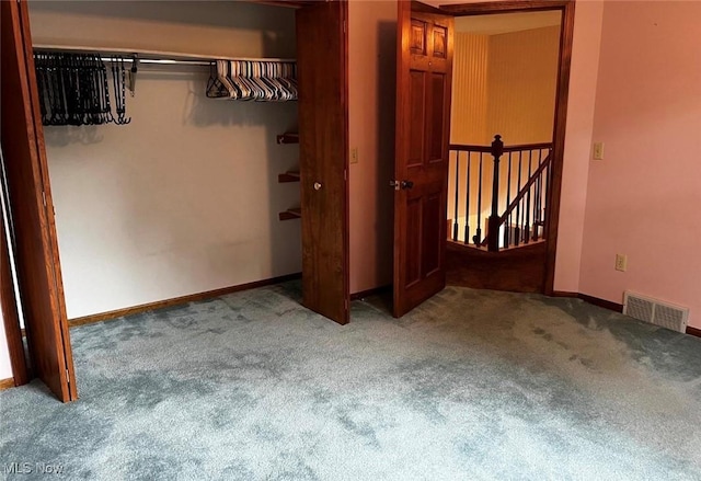 unfurnished bedroom featuring a closet and carpet flooring