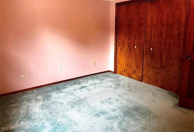 unfurnished bedroom with a closet and carpet