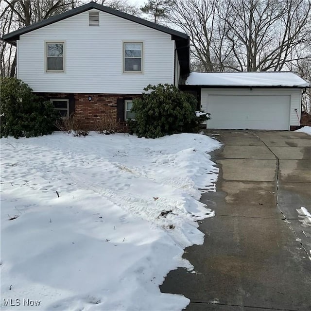 view of snow covered exterior with a garage