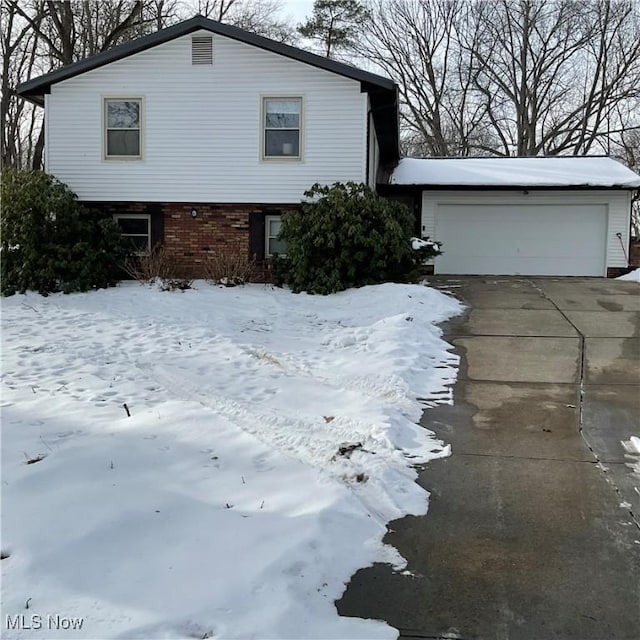 view of snow covered exterior featuring a garage