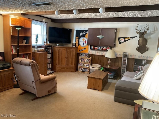 living room featuring light carpet and beam ceiling