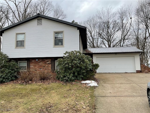 view of side of property featuring a garage and a lawn