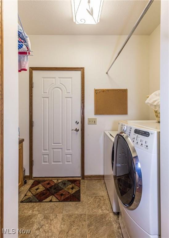 clothes washing area with washer and clothes dryer