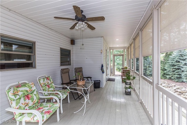 wooden terrace featuring ceiling fan and a porch