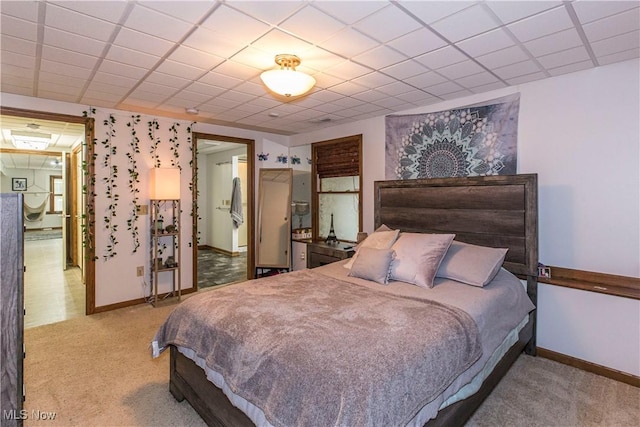 carpeted bedroom featuring a paneled ceiling