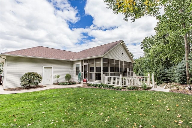 view of front facade featuring a front yard and a sunroom