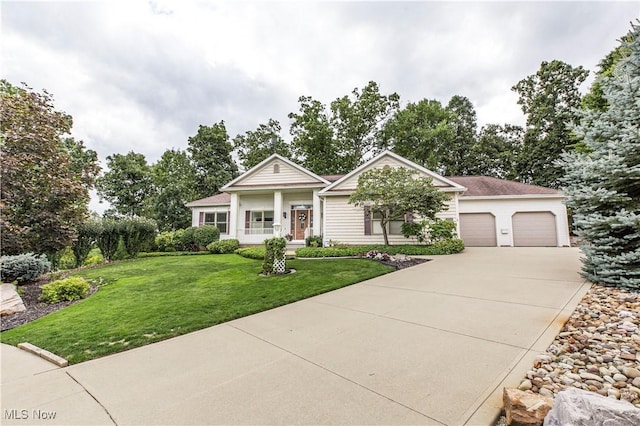 view of front of home featuring a garage and a front lawn