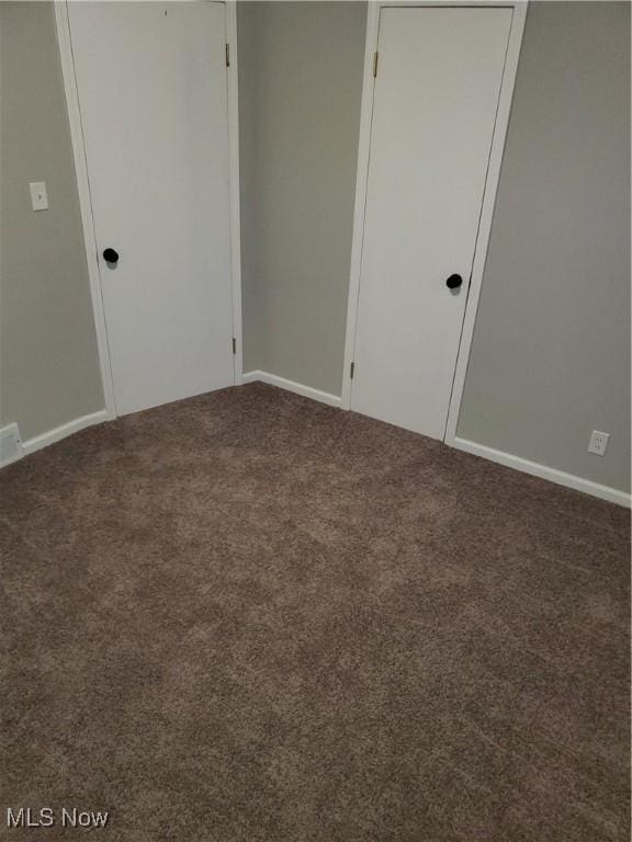 unfurnished bedroom with a closet and carpet