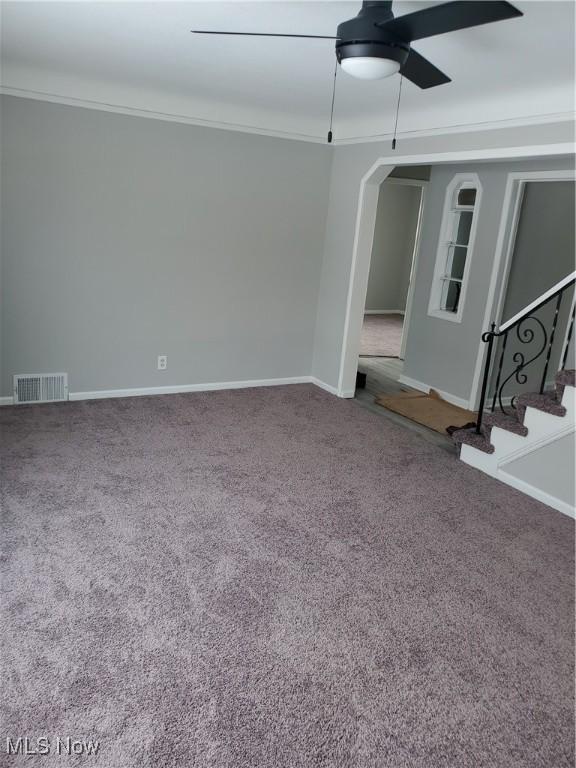 spare room with ceiling fan, ornamental molding, and carpet flooring