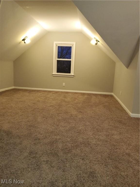 bonus room featuring lofted ceiling and carpet floors