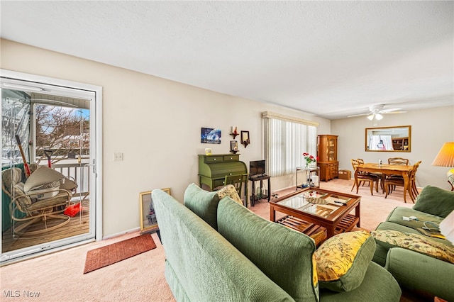 living room with plenty of natural light, light carpet, and ceiling fan