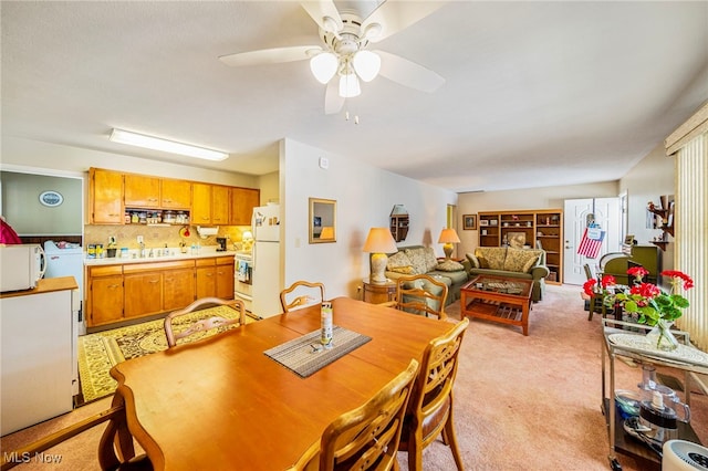 dining room with light carpet and ceiling fan