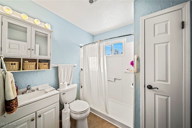 bathroom with vanity, toilet, a textured ceiling, and a shower with shower curtain