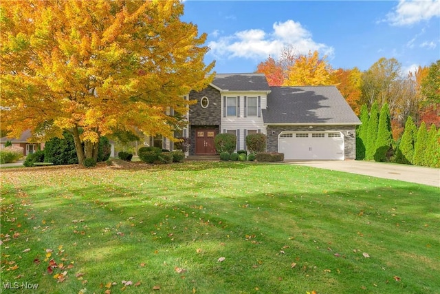 view of front of house featuring a garage and a front lawn