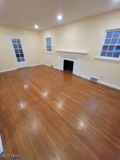 unfurnished living room with a brick fireplace