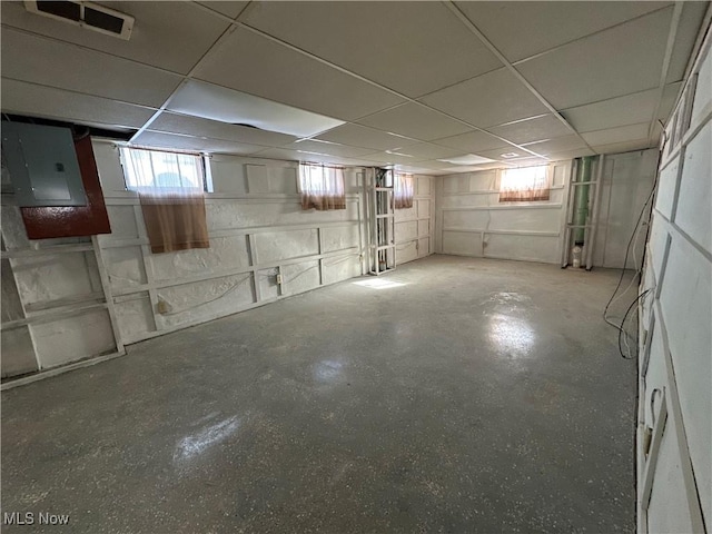 basement featuring electric panel and a drop ceiling