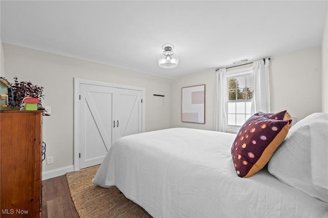 bedroom with dark wood-type flooring