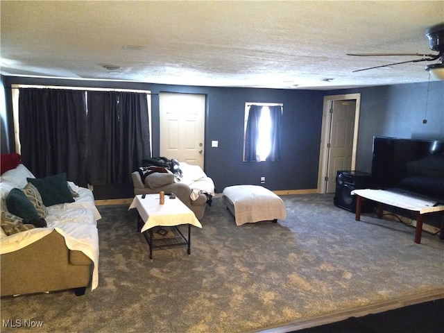 living room featuring dark colored carpet and a textured ceiling