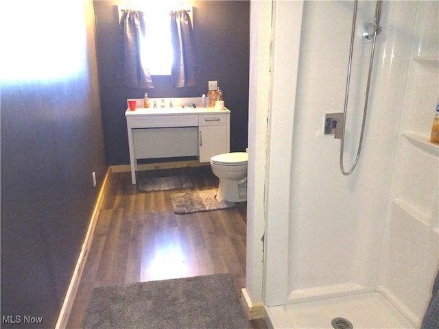 bathroom with vanity, hardwood / wood-style floors, toilet, and walk in shower