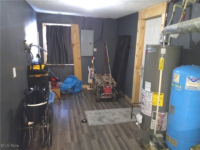 utility room with electric panel and water heater