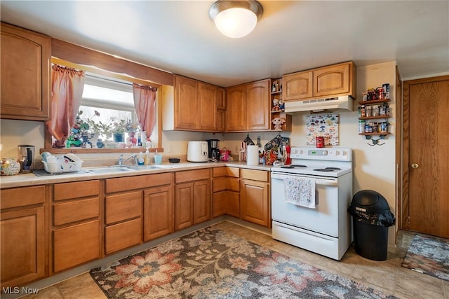 kitchen featuring light tile patterned floors, sink, and white range with electric stovetop