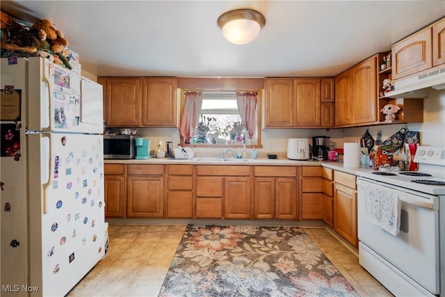 kitchen with sink and white appliances