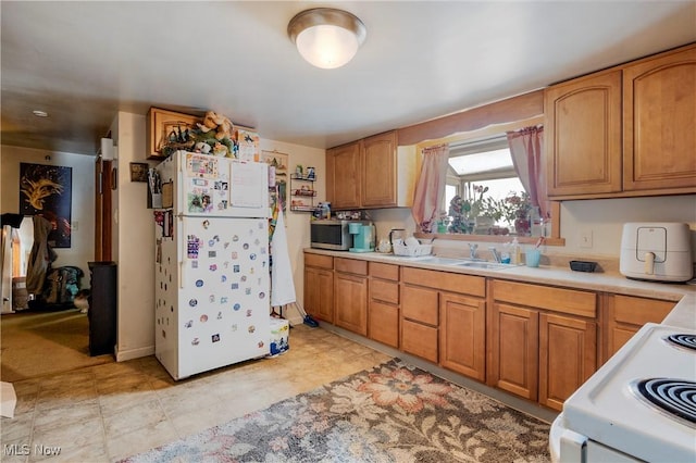 kitchen featuring sink and white appliances