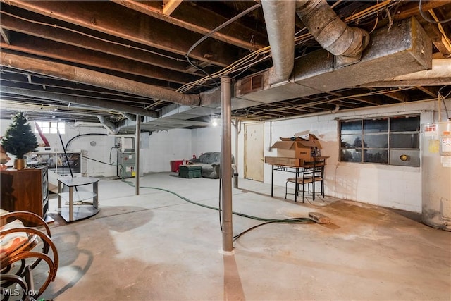 basement with heating unit and electric water heater