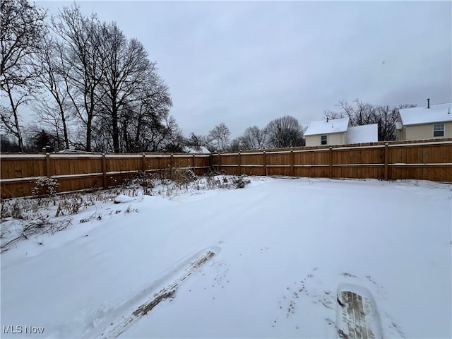 view of yard layered in snow