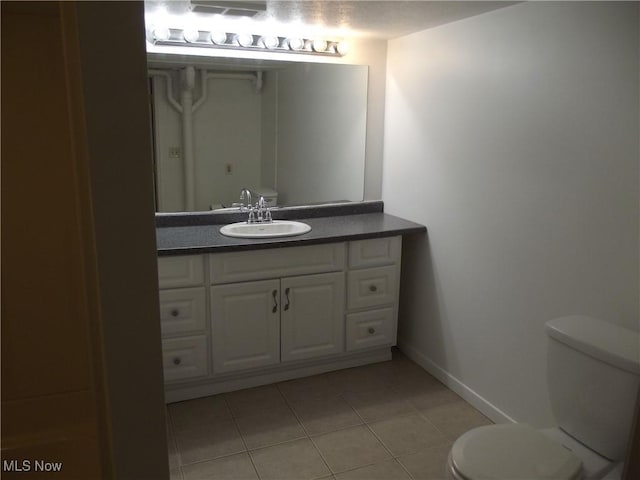 bathroom with tile patterned floors, toilet, and vanity