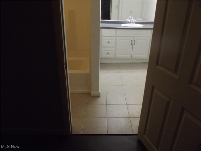 bathroom with tile patterned floors and vanity