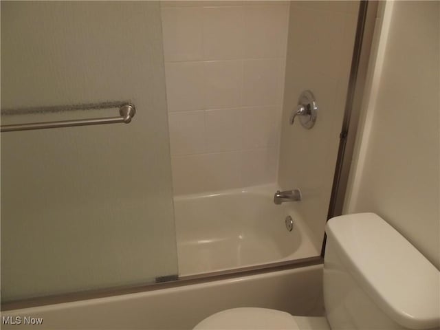 bathroom with shower / bath combination with glass door and toilet