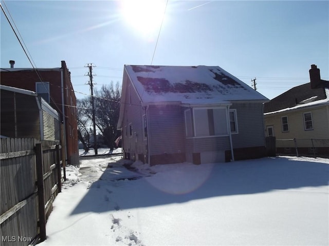 view of snow covered rear of property