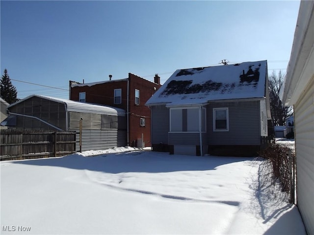 view of snow covered rear of property