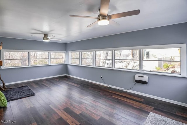 unfurnished room with ceiling fan, heating unit, and dark hardwood / wood-style flooring