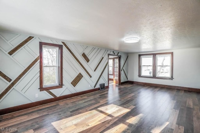 interior space with dark hardwood / wood-style floors and a textured ceiling