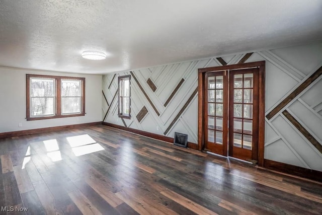 empty room featuring dark hardwood / wood-style floors and a textured ceiling