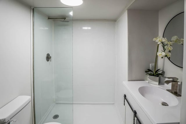 bathroom featuring vanity, a shower, and toilet