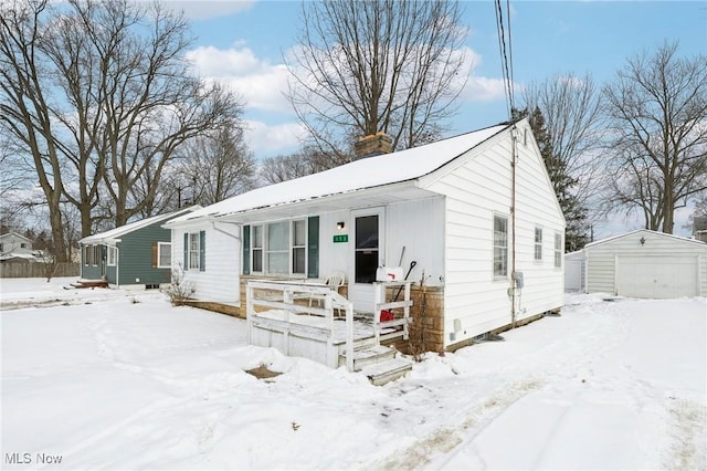 view of front of property with a garage and an outdoor structure