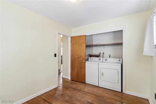 clothes washing area featuring hardwood / wood-style flooring and independent washer and dryer