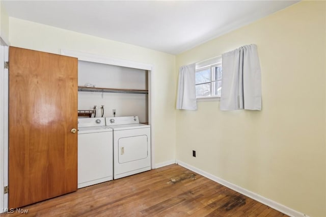 laundry room with independent washer and dryer and wood-type flooring