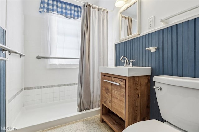 bathroom with vanity, curtained shower, and toilet