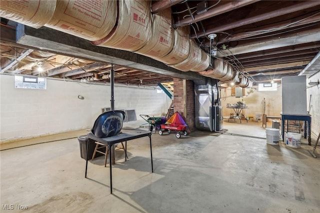 basement with heating unit and electric panel