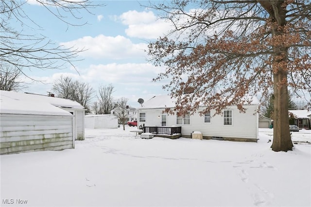 yard layered in snow with a deck