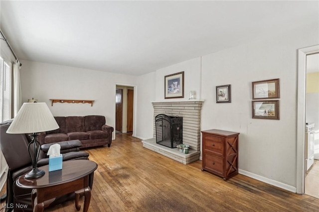 living room with hardwood / wood-style floors and a fireplace